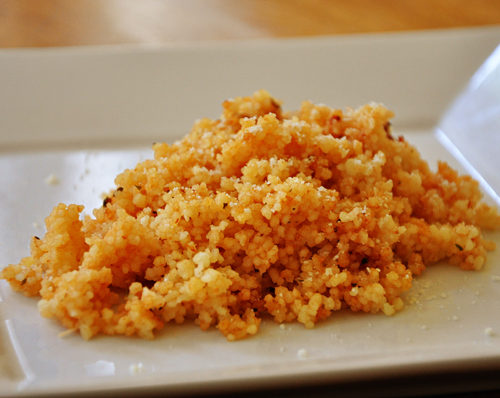 tomato parmesan couscous on a white plate