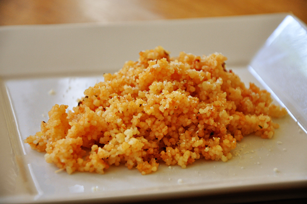 tomato parmesan couscous on a white plate