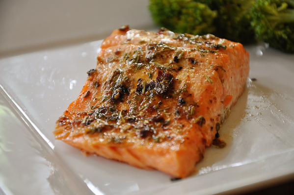 Piece of trout on a plate with broccoli