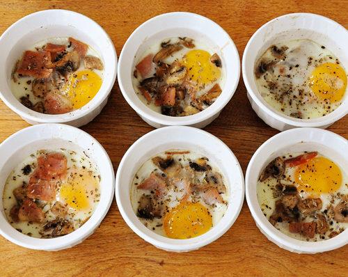 Traditional coddled eggs with bacon and mushrooms