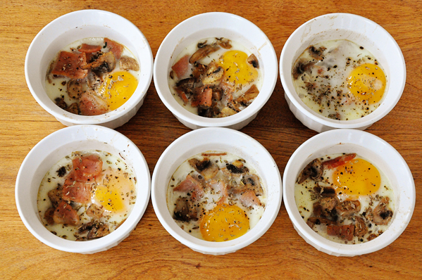 Traditional coddled eggs with bacon and mushrooms