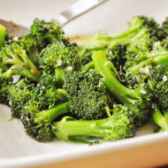Spicy steamed broccoli in a white bowl