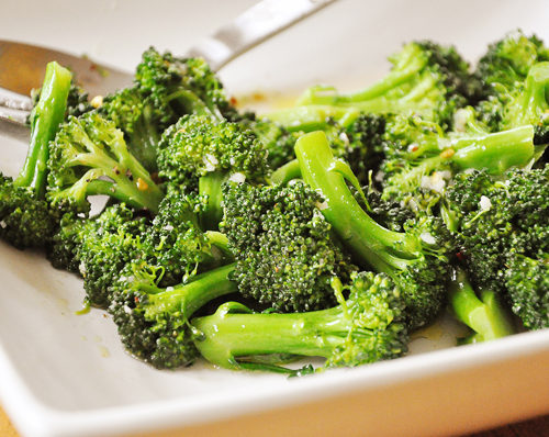 Spicy steamed broccoli in a white bowl