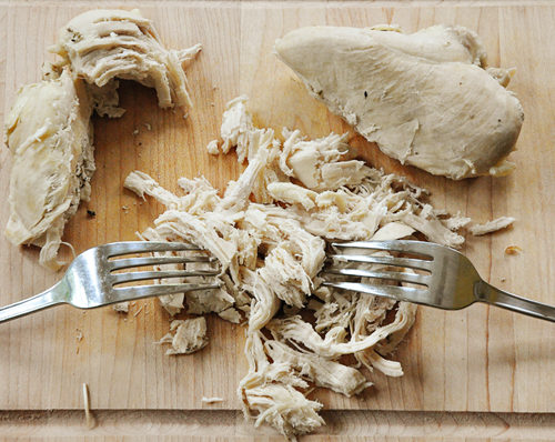 This recipe for all-purpose poached chicken breasts is made with garlic, onion and oregano for a simple low-fat shredded chicken recipe. | livinglou.com