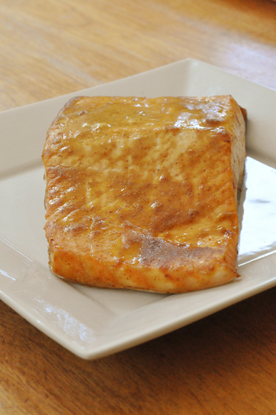 Fillet of sweet and spicy salmon on a white plate