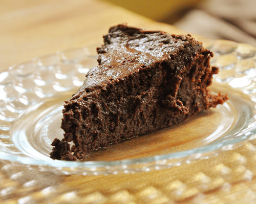 a slice of flourless chocolate cake on a plate