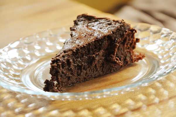 a slice of flourless chocolate cake on a plate