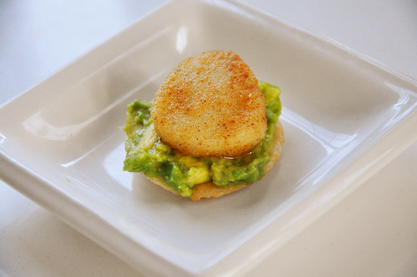 spicy seared scallops on top of avocado on a rice cracker