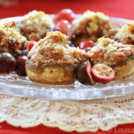 cranberry stuffed mushrooms on a crystal plate on a tuille napking