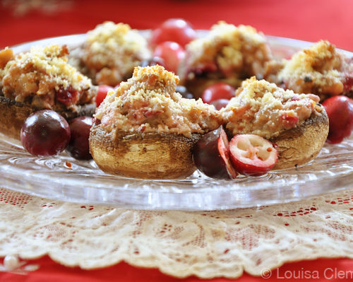 cranberry stuffed mushrooms on a crystal plate on a tuille napking