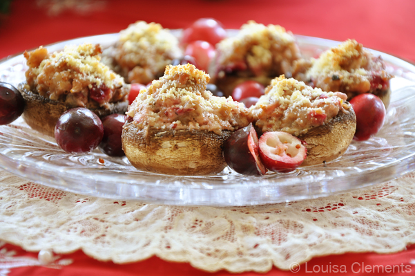 cranberry stuffed mushrooms on a crystal plate on a tuille napking