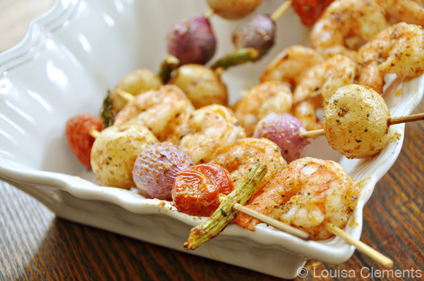 Cooked shrimp and vegetable skewers in a bowl