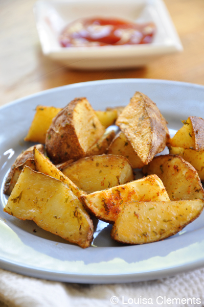 Oven fries on a plate with ketchup