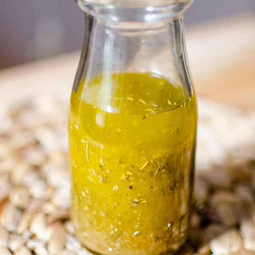 A glass jar filled with white balsamic vinaigrette