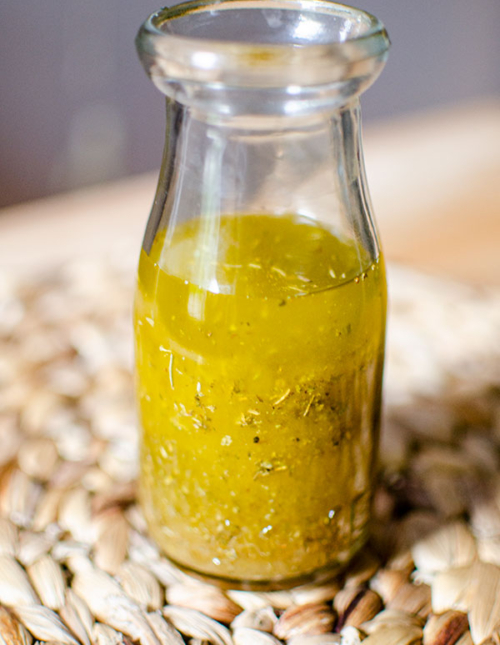 A glass jar filled with white balsamic vinaigrette