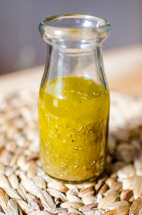 A glass jar filled with white balsamic vinaigrette