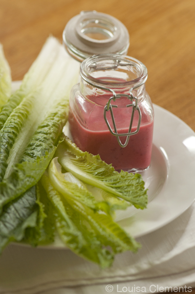 Cranberry vinaigrette in a jar with romaine lettuce