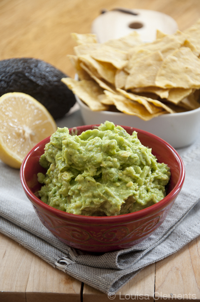 A bowl of easy, fresh guacamole with a plate of chips