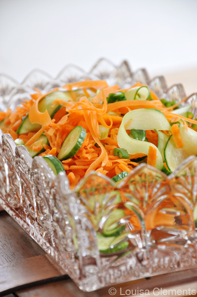 Carrot salad with cucumbers in a glass bowl
