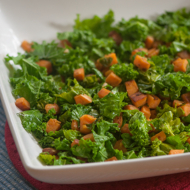 Sauteed kale with sweet potatoes in a white bowl