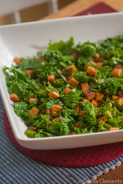 Sauteed kale with sweet potatoes in a white bowl