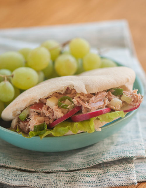 Tuna salad in pita pockets with grapes on the side