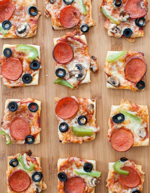 puff pastry pizza bites cut into squares on a cutting board