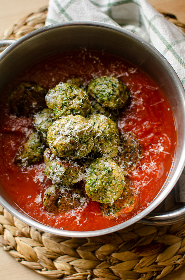 Meatballs in marinara sauce in a pot.