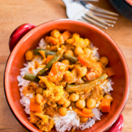 A serving of curry over rice in a bowl