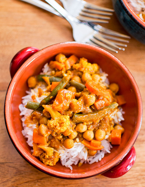 A serving of curry over rice in a bowl