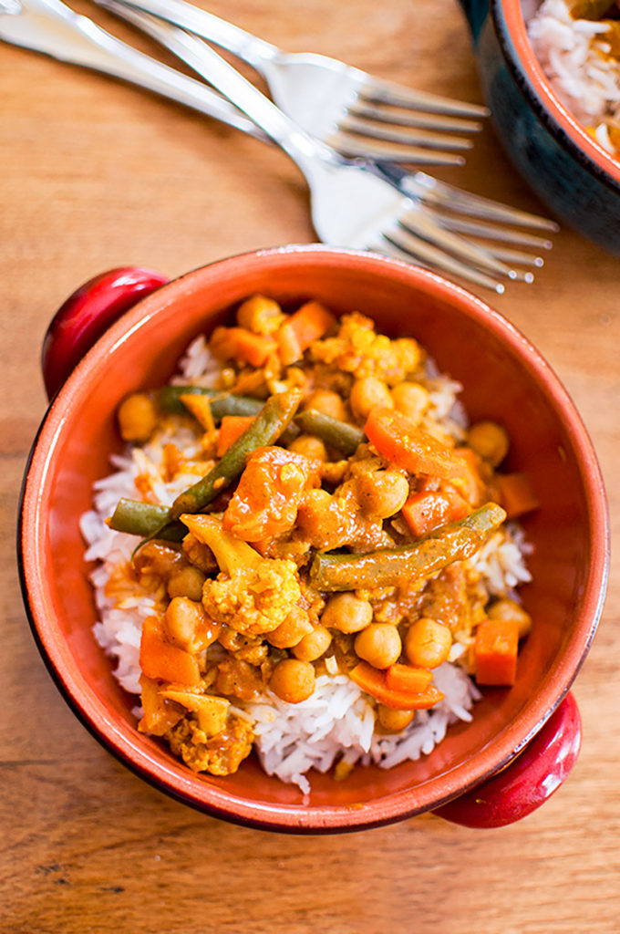 A serving of curry over rice in a bowl