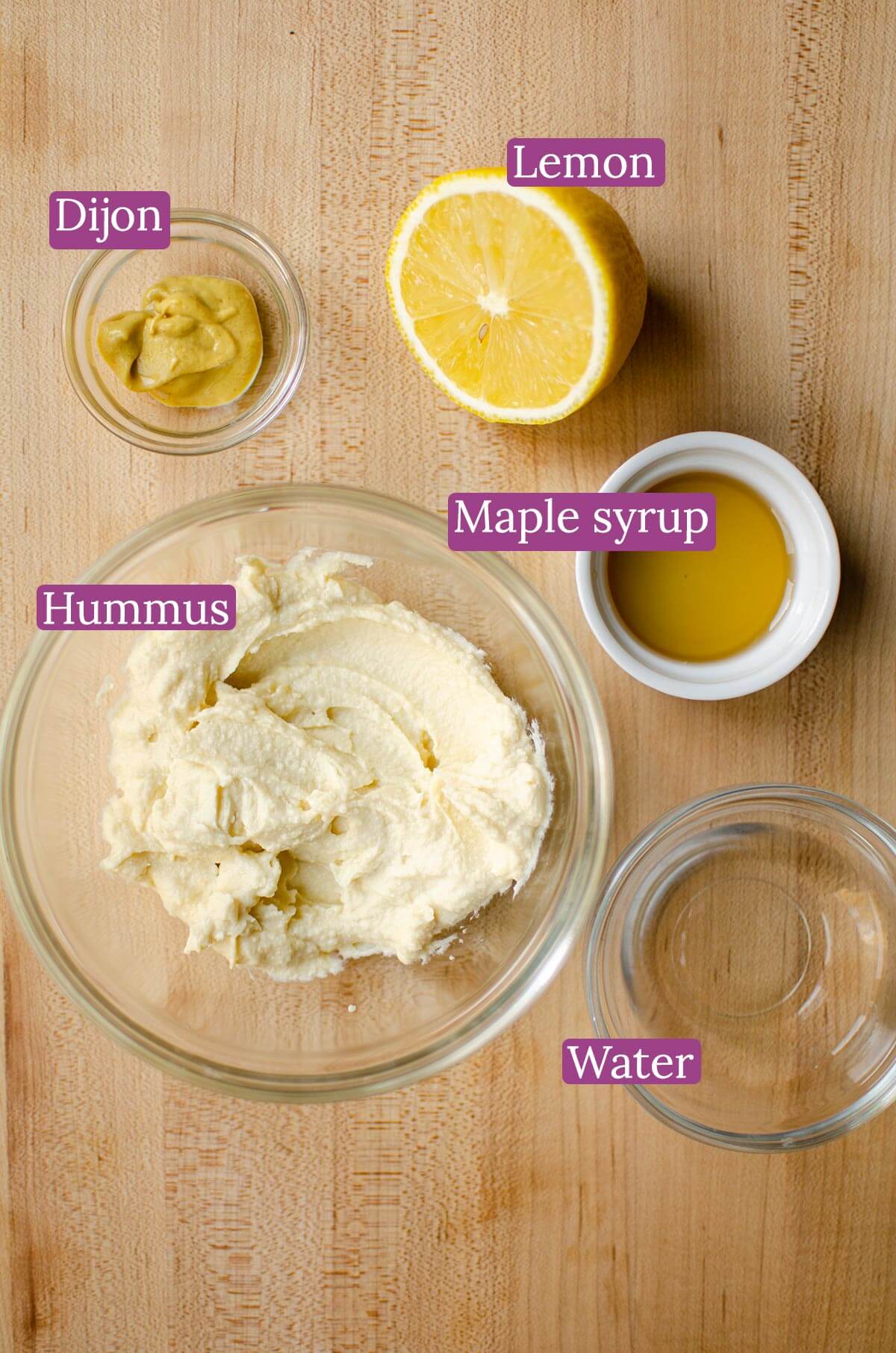 Ingredients for dressing in glass bowls on a table.