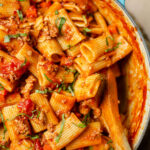 Closeup of rigatoni bolognese in a Dutch oven.