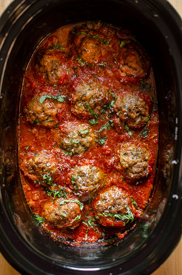 Italian beef meatballs in the slow cooker with tomato sauce.