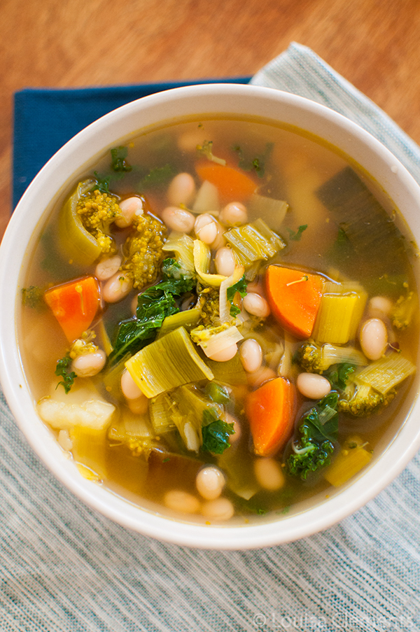 Packed with goodness, this healthy six vegetable white bean soup is elevated with the addition of pesto swirled in at the end! | Livinglou.com