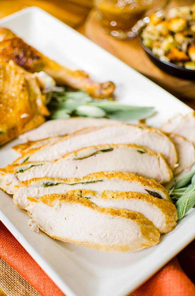 Sliced turkey breast with stuffing in the background.