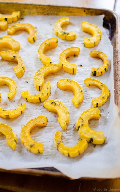 A sheetpan of sliced, roasted delicata squash.