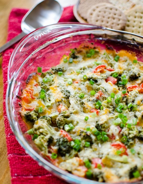 The perfect appetizer for entertaining or for game day, this cheesy broccoli dip is a healthier vegetarian option loaded with broccoli and red peppers. | livinglou.com