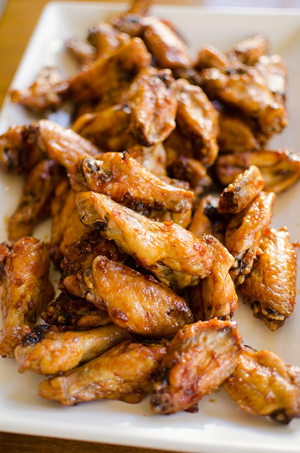 Make your favourite wings in the oven with this crispy recipe for baked teriyaki chicken wings made with baking powder and a homemade teriyaki sauce. | livinglou.com