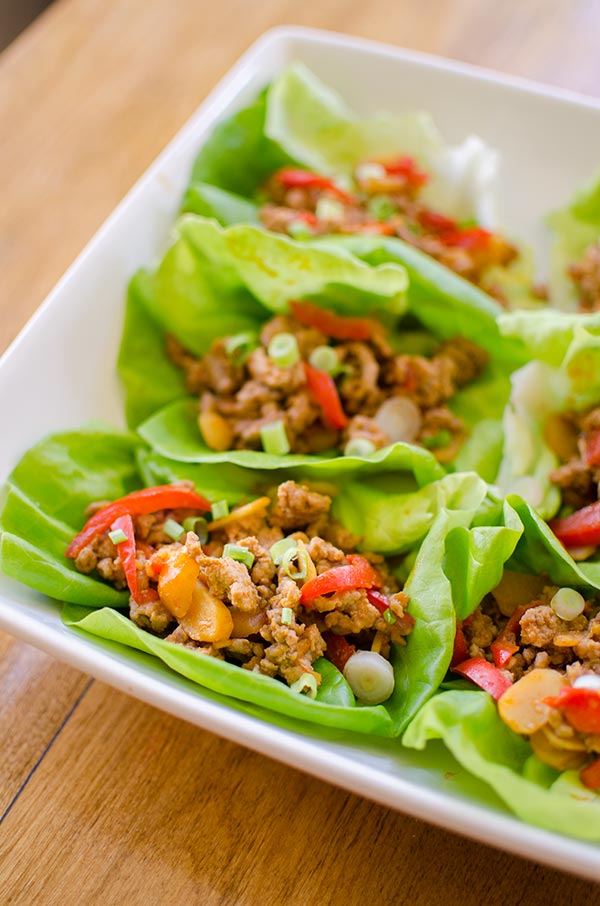 A healthy chicken lettuce wrap made with red peppers, ginger and water chestnuts. | livinglou.com