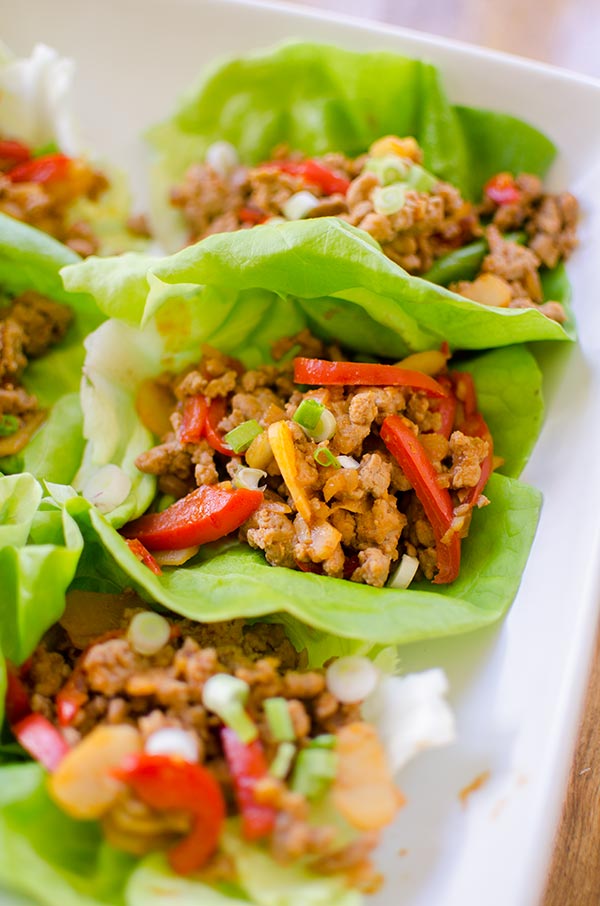 A healthy chicken lettuce wrap made with red peppers, ginger and water chestnuts. | livinglou.com