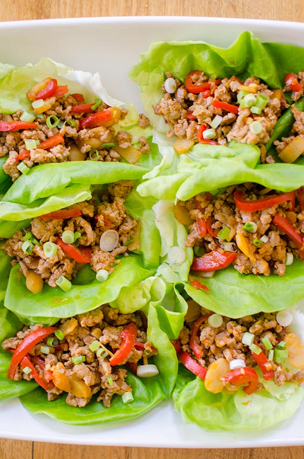 A healthy chicken lettuce wrap made with red peppers, ginger and water chestnuts. | livinglou.com