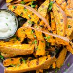 Closeup of grilled fries with dip.