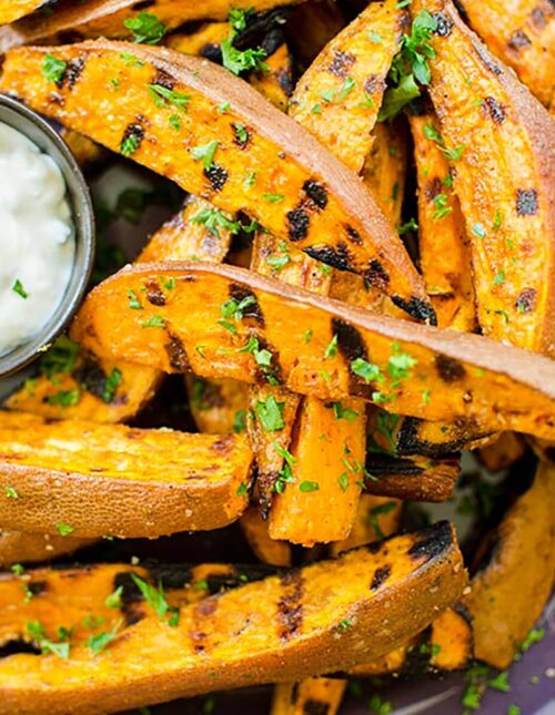 Closeup of grilled fries with dip.