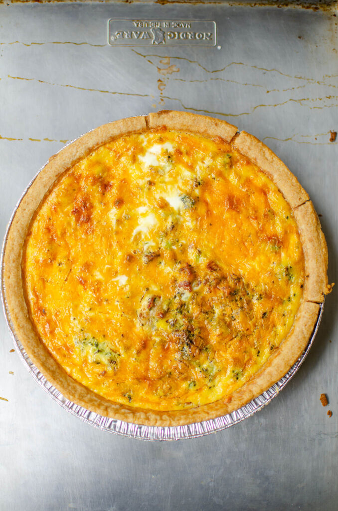 Fully baked quiche on a sheet pan.
