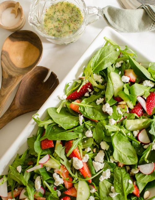 Strawberry spinach salad with almonds, arugula and a homemade poppy seed dressing with fresh thyme. | livinglou.com
