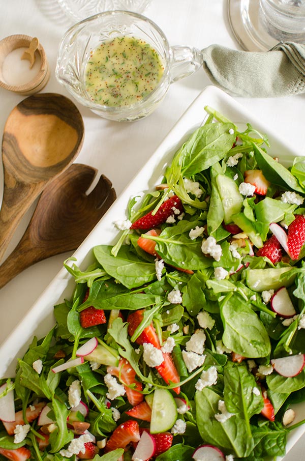 Strawberry spinach salad with almonds, arugula and a homemade poppy seed dressing with fresh thyme. | livinglou.com