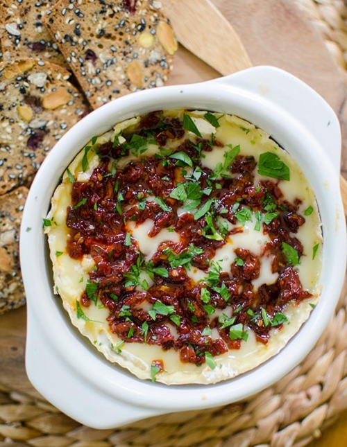 Baked Camembert cheese with sun dried tomatoes and red pepper jelly is the perfect appetizer. | livinglou.com