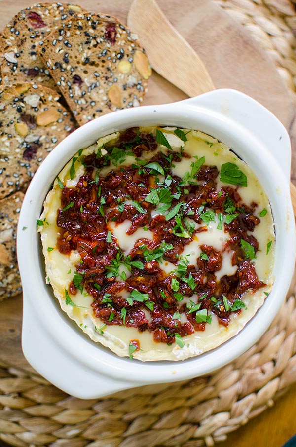 Baked Camembert cheese with sun dried tomatoes and red pepper jelly is the perfect appetizer. | livinglou.com
