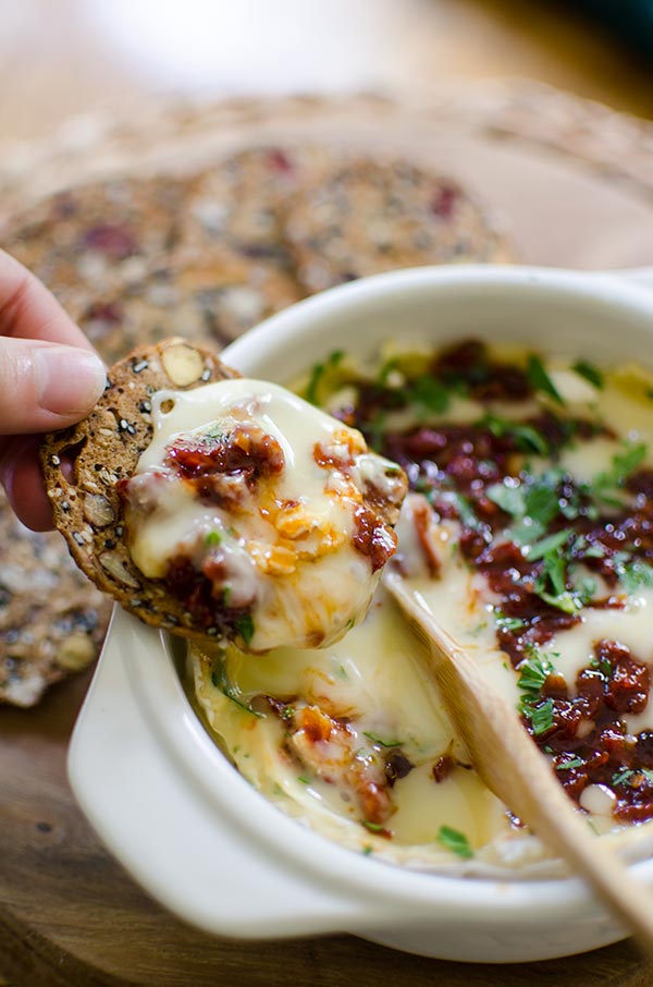 Baked Camembert cheese with sun dried tomatoes and red pepper jelly is the perfect appetizer. | livinglou.com